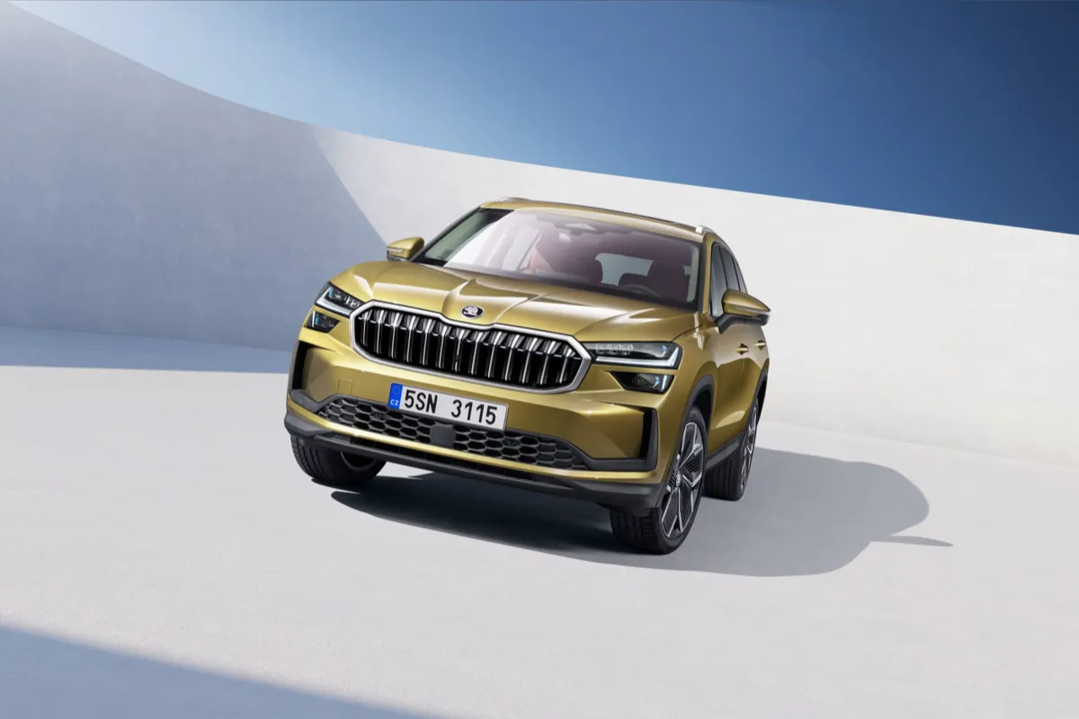 Skoda Kodiaq doré vu de trois quarts avant dans un décor de studio clair